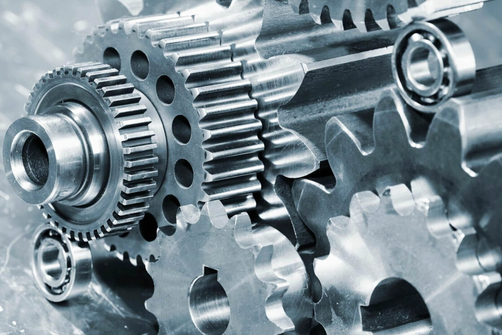Close-up of shiny metal gears interlocking in a mechanical system.
