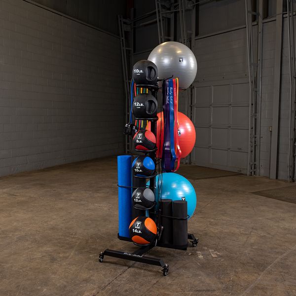 Organized rack with kettlebells, resistance bands, exercise balls, and yoga mats in a gym.